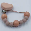 Heart-shaped beechwood and silicone bead pacifier clip in earthy tones - Khaki