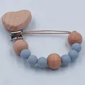 Baby pacifier clip featuring blue silicone beads and a beech wood heart-shaped clip detail - Grey Blue