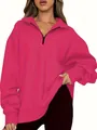 Close-up of the front half-zip fastening on a hot pink long sleeve athletic sweatshirt - Rose Red