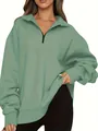 Detailed view of women's sage green half-zip pullover sweatshirt with black zipper - Light Green