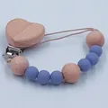 Blue silicone and beech wood baby pacifier clip with a natural heart-shaped wooden fastener - Lilac Purple