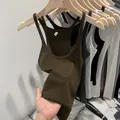 Close-up of slim fit ribbed knit tank top camisole for women showing fabric elasticity - Dark Coffee