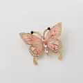 Detailed view of a vintage butterfly brooch with pink enamel wings and rhinestones. - Luxury Pink Crystal Butterfly Brooch