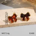 Boucles d'oreilles nœud ambre vintage avec bord en acier doré, taille 2cm - Nœud Ambre Vintage (BJGE2408)