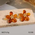 Boucles d'oreilles fleur en résine ambre vintage avec centre doré, ton orange Maillard - Clous Fleur Ambre (BJGE2398)