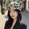 Stylish leopard print sailor hat for women featuring decorative metal buckles on street - Cream Leopard Buckle