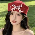 Stylish red sailor hat for women featuring a heart patterned bow and pearl accents - Red Sailor Hat with Bow and Rhinestones / Red