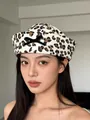 Stylish leopard print sailor hat with a black bow accent on an Asian female model. - Leopard Print Sailor Hat with Black Bow / Leopard Print