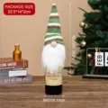 Christmas gnome wine bottle cover with green striped knit hat for holiday table decor - Green
