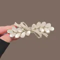 Elegant gold hair clip with white pearlescent leaves and small pearl accents - Gold Cat Eye Leaf Bowknot Spring Clip