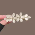 Elegant golden floral spring hair clip with white opal-like petals and rhinestones. - Gold Cat Eye Stone Double Flower Spring Clip