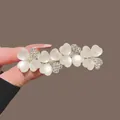 Elegant golden hair clip with translucent heart petals and sparkling crystal accents. - Gold Cat Eye Rhinestone Four-Leaf Clover Spring Clip