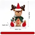 Sitting Christmas reindeer plush doll featuring a red Santa hat and green knitted scarf - Red and Green Knitted Sitting Reindeer Figurine