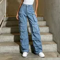 Detailed view of light wash multi-pocket cargo denim pants with a wide-leg fit. - S / Bottoms / Light Blue