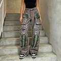 Detailed view of high-waisted washed cargo jeans with green distress and multi-pockets - S / Bottoms / Graffiti