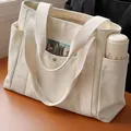 Spacious cream canvas tote bag with functional side pockets and minimalist commuter style - Upgraded Version with Lining / Off White