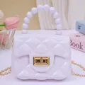 Mini purple jelly shoulder bag featuring pearl handle and classic quilted pattern - White