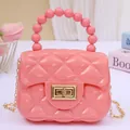 Quilted pink jelly mini shoulder bag with bead handle and elegant gold chain strap - Pink