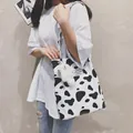 Stylish black and white cow print canvas tote bag with a cute plush bear charm accessory - Cow Print (Bag Only) / Cow Print