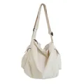 Minimalist cream white canvas messenger bag with adjustable strap and side pockets - White