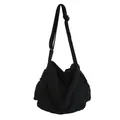 Minimalist black canvas messenger bag for students featuring adjustable shoulder strap - Black