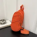 Versatile orange nylon sling bag for sports and daily commute, showing side details. - Orange Red