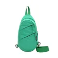 Front view of a minimalist green nylon sling bag with multiple zipper compartments. - Green