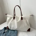 Large capacity white travel tote bag for women with brown leather handles and accents. - White
