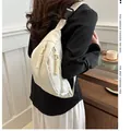 Casual off-white nylon fanny pack for commuting and sports, worn on model's back - White