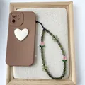 Detail of green bamboo beads and pink tulip charm on a Chinese style phone strap. - S-S24003A (Green Bamboo Tulip)