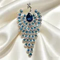 Macro view of an elegant retro peacock brooch with blue crystals on white satin folds - Multicolor Rhinestone Peacock (567-2) / Blue (567-2)
