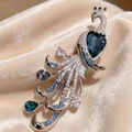 Detailed view of a luxury silver peacock brooch featuring blue and clear crystals - Chinese Style Peacock (588-1) / Chinese Style Blue Rhinestone (588-1)
