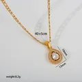Close-up detail of a gold teardrop pendant necklace with sparkling clear crystals. - Water Drop Halo Pendant (G30) / Gold