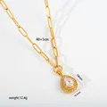 Detailed macro view of golden stainless steel teardrop pendant necklace with clear stones - Paperclip Chain Water Drop Pendant (G33) / Gold
