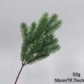 Detailed view of artificial green pine branch for Christmas decoration and landscaping - Fir Spray (50cm)