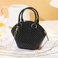 Fashionable black mini jelly shell bag featuring a beaded texture and elegant gold chain strap - Black