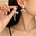 Elegant bow-knot earrings with white pearls and black polka dots in a stylish finish - Artificial Pearl Bow Long Earrings (2747)
