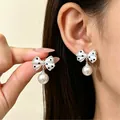 Elegant black and white polka dot bow earrings with hanging pearl drops in a vintage style - Artificial Pearl Polka Dot Bow Drop (N-733)