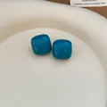 Minimalist teal blue enamel stud earrings with silver needles featuring a rounded square design - Sky Blue