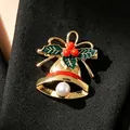 Elegant Christmas gold bell brooch with holly leaves and pearl on black fabric. - Christmas Bell