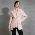Detailed view of pink tailored blazer with unique waist pleats and single button. - S / Pink