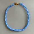 Close-up of blue abacus bead necklace with gold toggle clasp and white accents. - 43cm / Blue Stone with White Rice Beads