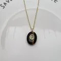 Détail d'un pendentif ovale élégant en pierre naturelle avec zircon sur chaîne d'or. - Pendentif Uniquement (Sans Chaîne) / Œil de tigre