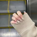 Detailed close-up of handmade long press-on nails featuring a nude and white gradient design. - S Small / 124-Long Coffin Style (124) / Nude Pink Gradient