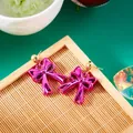 Vibrant magenta resin bow stud earrings for women with metallic accents for daily wear - Rose Red