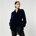 Close-up of navy blue velvet blazer featuring wrap belt with elegant tassel fringe details. - S / Navy Blue
