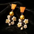 Vintage drop earrings featuring orange trapezoid tops and delicate pearl flower clusters - Orange Wooden Pearl Zirconia Flower (2608236)