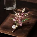 Macro detail of elegant wheat bouquet brooch with pink crystals and pearls on dark wood base - Harvest Wheat Ear (Pink) / Pink