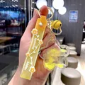 Yellow sakura quicksand keychain with real flower petals and Happy Moments silicone strap - Yellow
