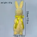 Detail view of a yellow glittery Easter bunny figurine with size measurements - 33cm Height / Yellow